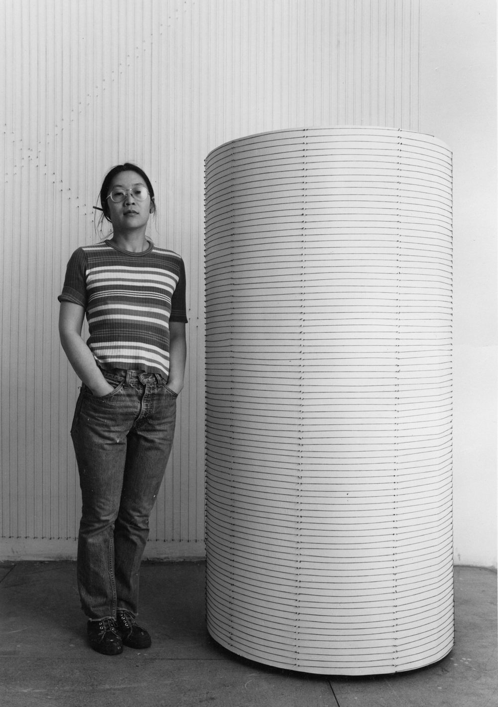 Kazuko Miyamoto standing by String around a cylinder of my height, 1973